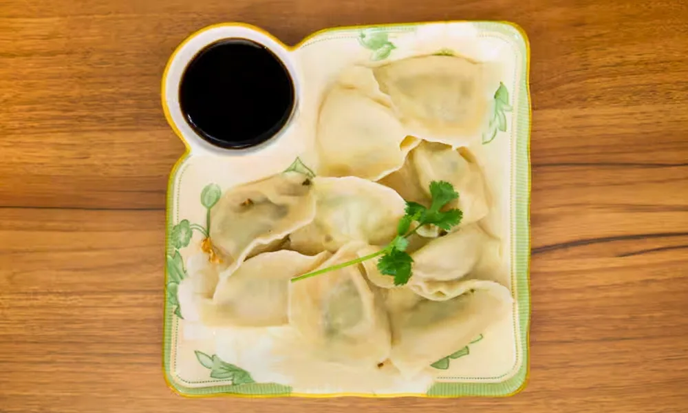Boiled dumplings with vinegar dipping sauce at Top SF BBQ, a Barbecue Restaurant in San Francisco