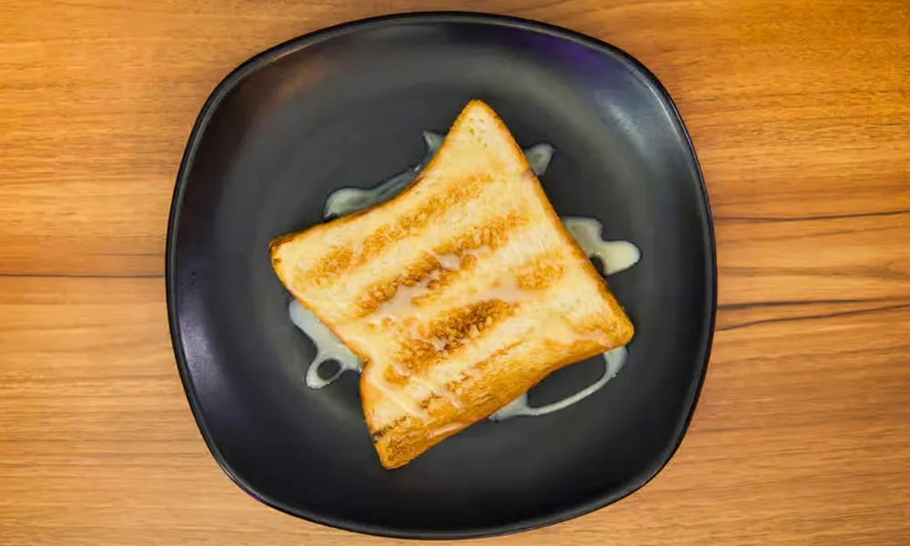 Grilled toast drizzled with sweet cream at Top SF BBQ, a Barbecue Restaurant in San Francisco