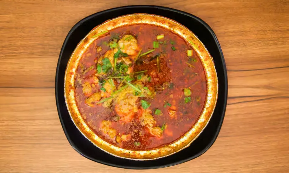 Spicy boiled shrimp in rich red chili broth at Top SF BBQ, a Barbecue Restaurant in San Francisco